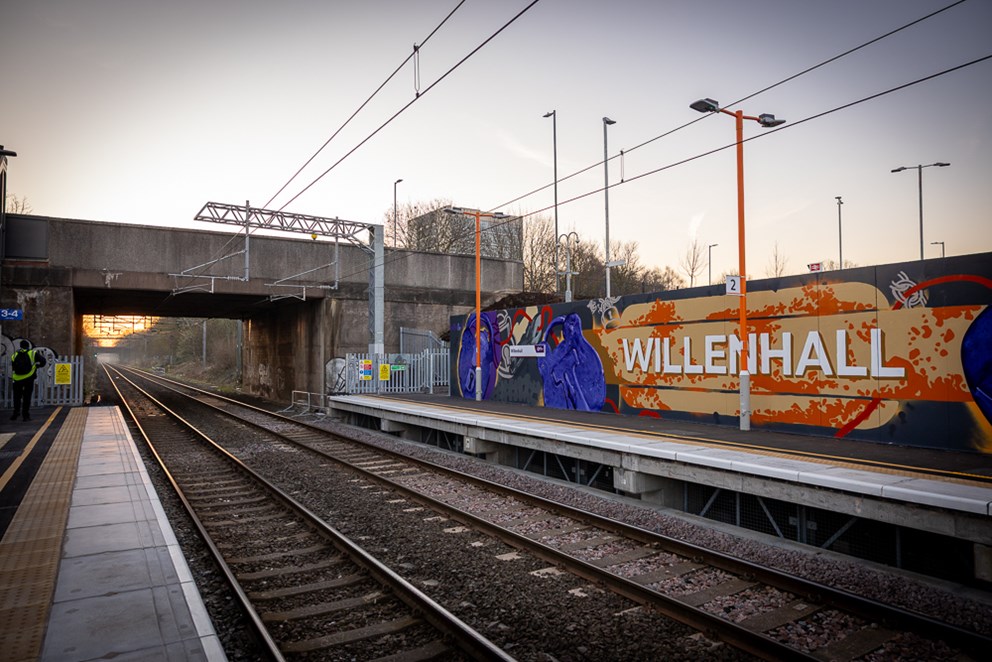 An image of the train tracks at Willenhall railway station. On the far wall there is some graffiti artwork.
