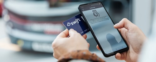 A person holding their swift card against their phone. The collector application is open on the phone.